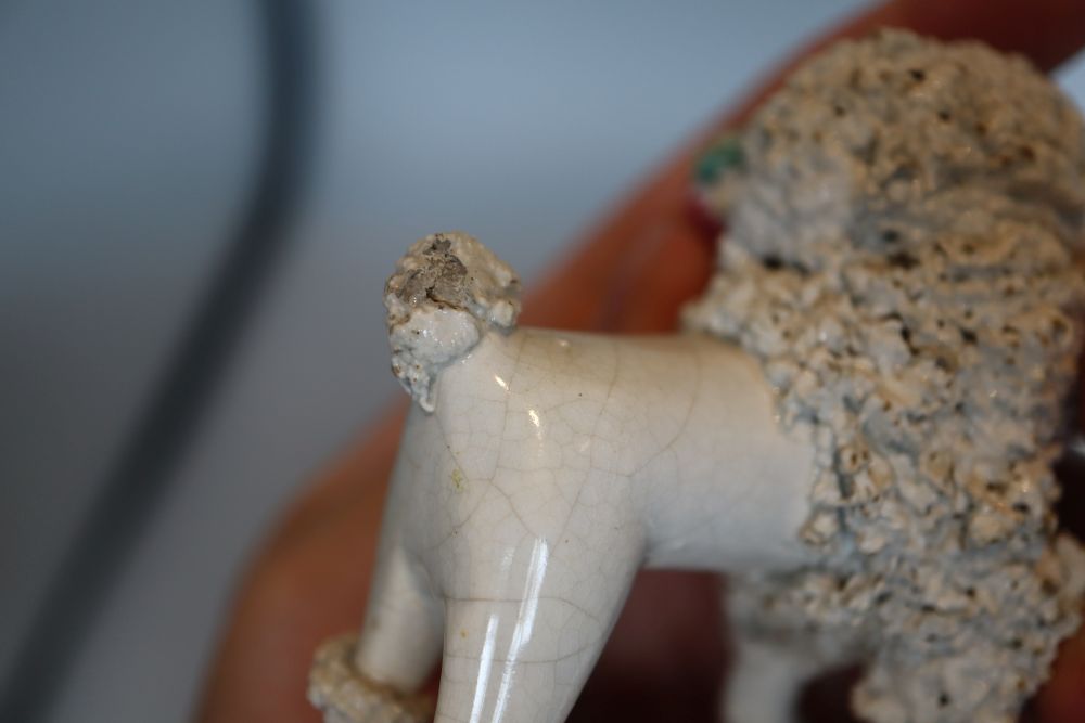 Four Staffordshire porcelain figures of a poodle grasping a basket in its mouth, c.1840 -50, H. 6.4 - 12cm
